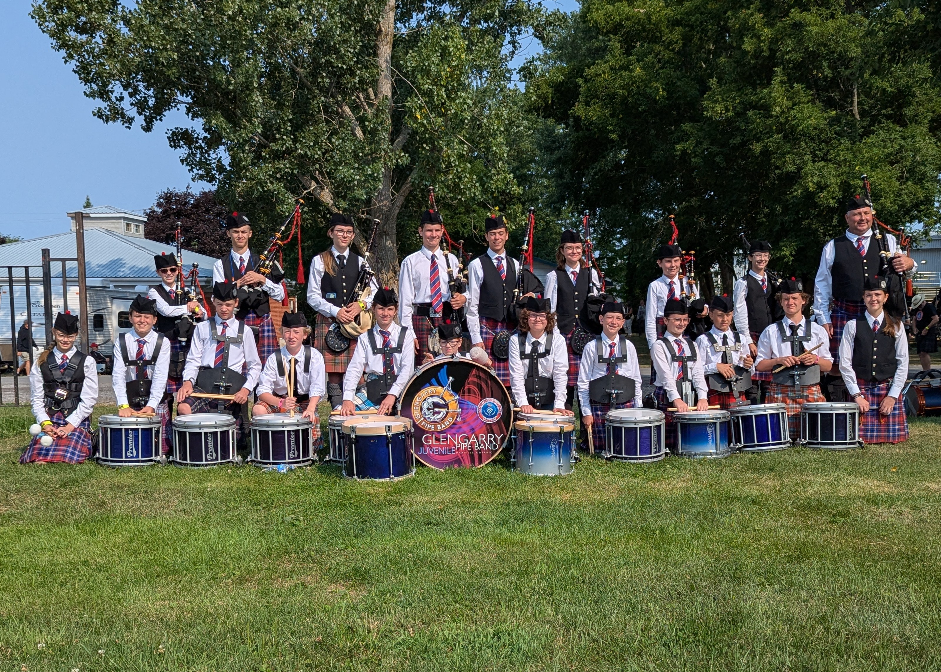 Group photo of the Glengarry Juvenile Pipe Band members at the Glengarry Highland Games